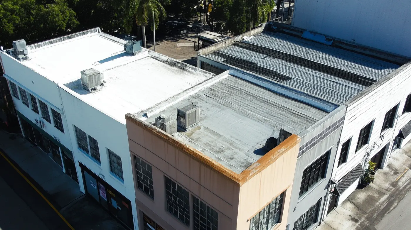 Aerial view of commercial buildings showing different roof types and HVAC units
